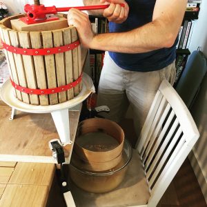Small apple press being used on a dining table