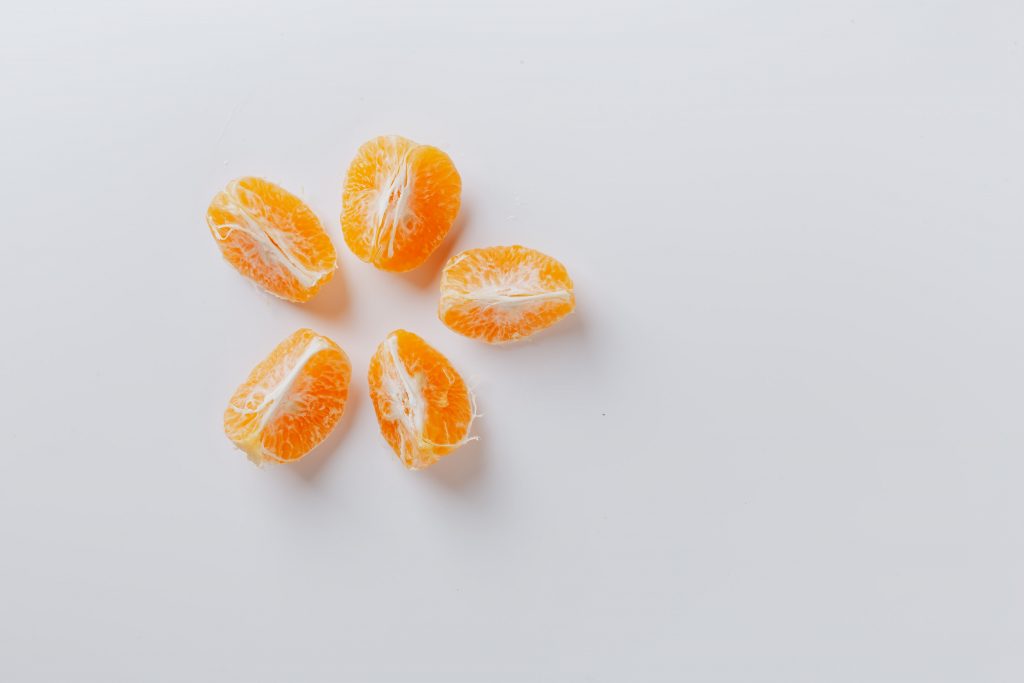 Peeled Juicy Orange on white background (image courtesy of Karolina Grabowska)